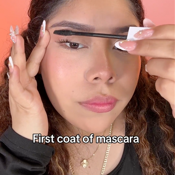Starting at the base of the lashes, wiggle the wand upward to apply the first coat.